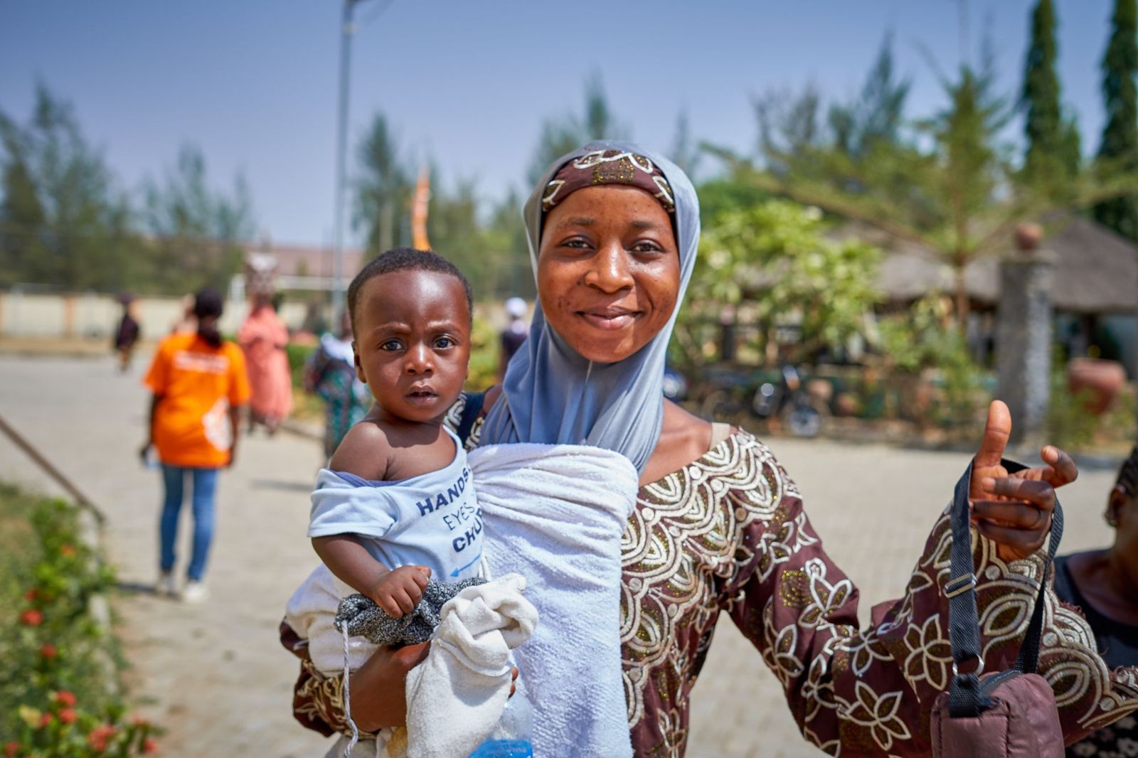 A joyful mother holding her baby in Keffi, Nigeria